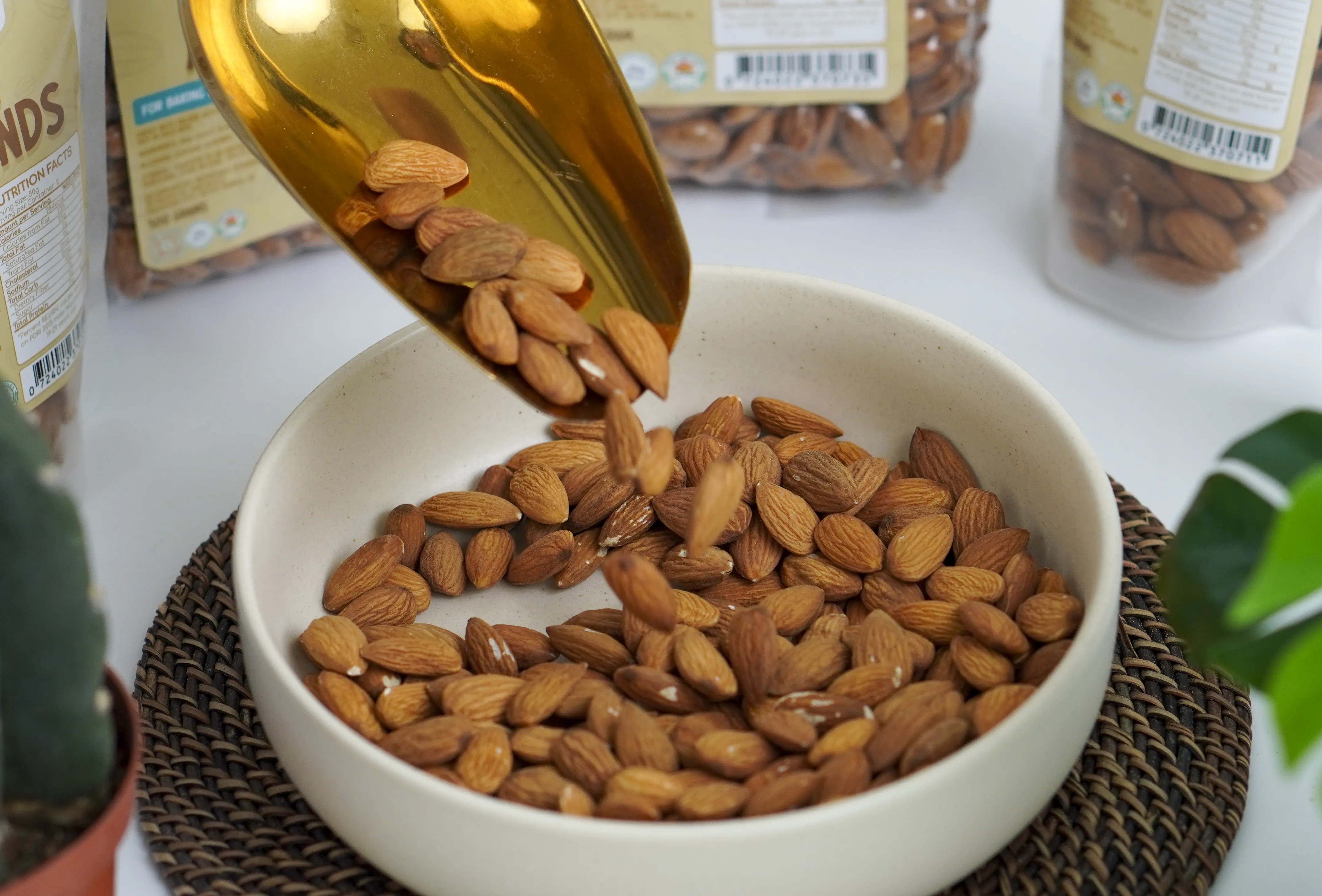 Bowl of raw walnuts beside Nutrifinds packaging